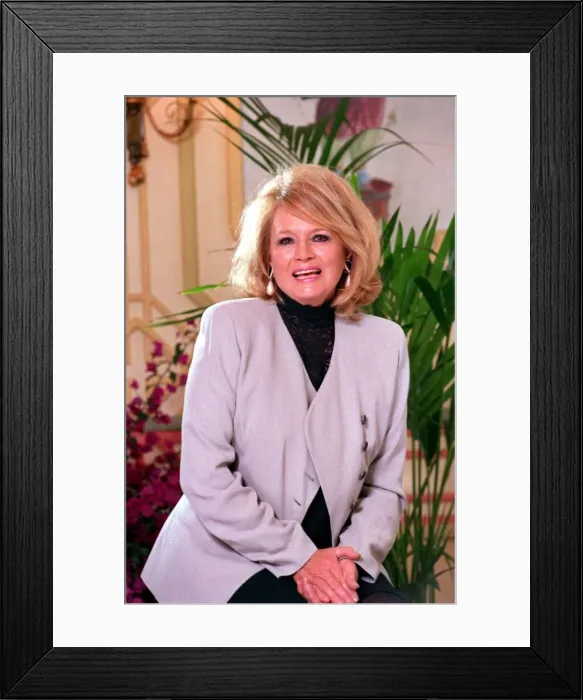 Framed Print : ANGIE DICKINSON WEARING JACKET AND SKIRT SITTING ON STOOL AT PHOTOCALL - 14  /  10  /  1993
