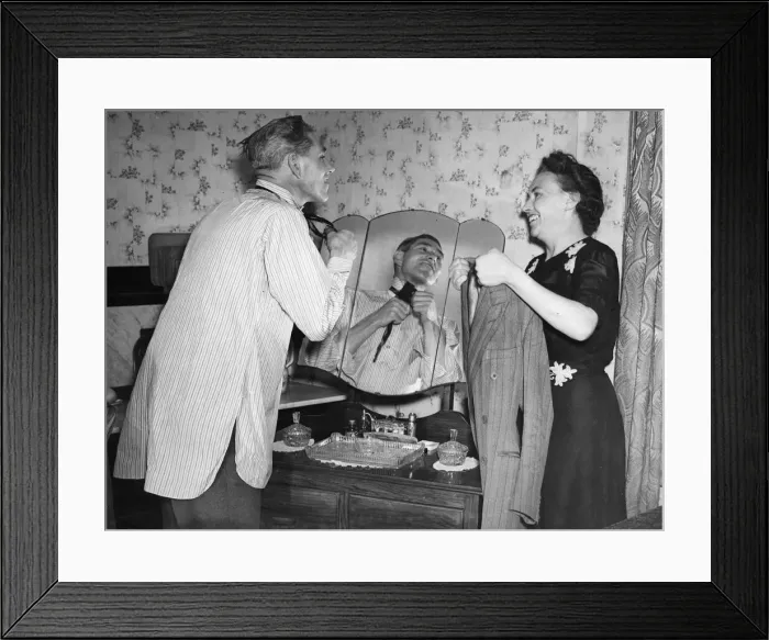 Framed Print : Bombardier Reg Kraushaar of Deptford and wife, pictured putting on his tie Framed Print : Bombardier Reg Kraushaar of Deptford and wife, pictured putting on his tie