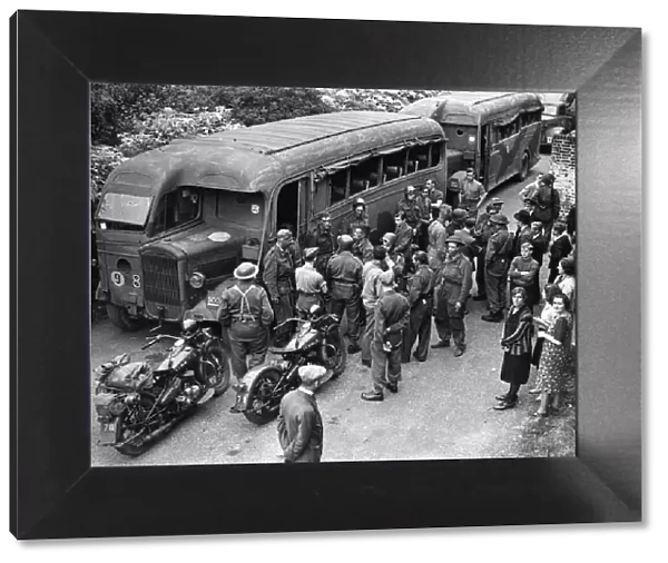 Troops enter their coaches after returning from the biggest ever Combined Operations