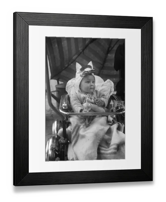 Framed Print : Picture shows a baby in Brussels, Belgium, wearing a bonnet with the British regiment