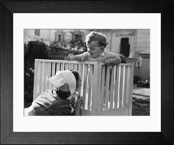 Framed Print : An eleven month old baby boy plays in his cot at the London nursing home where he was Framed Print : An eleven month old baby boy plays in his cot at the London nursing home where he was