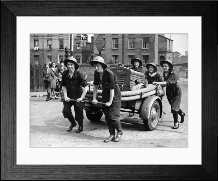 Framed Print : Five sisters form a fire fighting team on a trailer pump and are seen here at practice