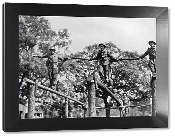 Soldiers crossing a log bridge during an inter-team competition held on an East Riding