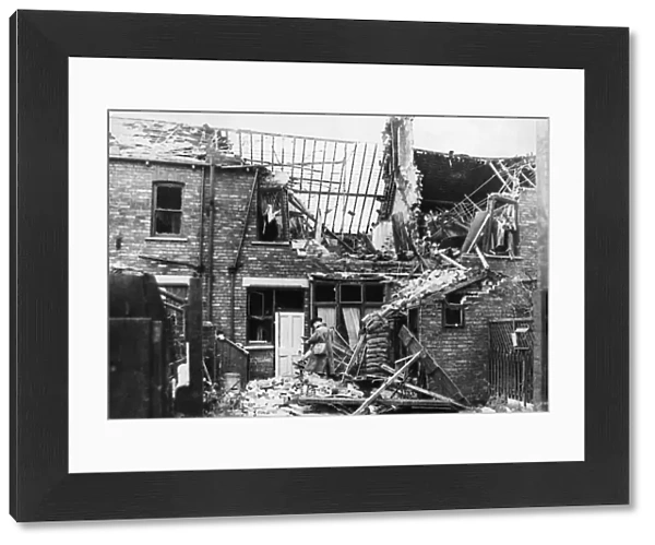 Scene of destruction showing damage to housing at the rear of 134