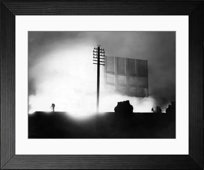 Framed Print : Destruction caused by air raids in Cardiff, Wales. A building ablaze. May 1943 Framed Print : Destruction caused by air raids in Cardiff, Wales. A building ablaze. May 1943