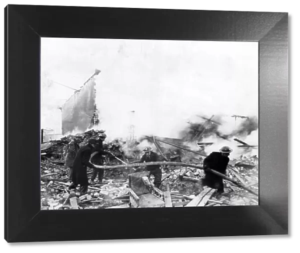 Firemen tackle blazing ruins at Llanbleddian Gardens, Cardiff, following air-raid attacks