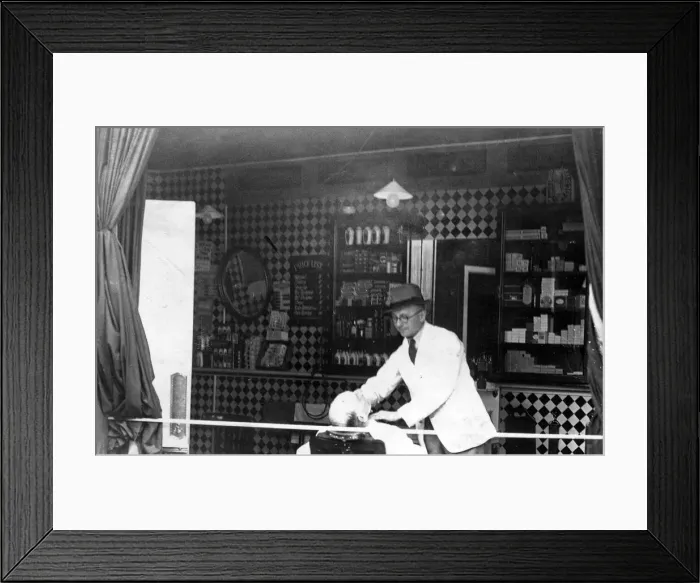Framed Print : Business as usual - this hairdresser carries on though his windows were blown by a bomb