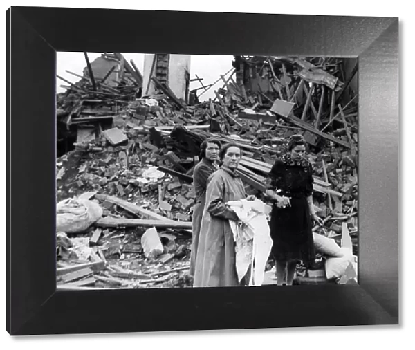 Women salvaging their belongings from their homes following an air raid in Rogerstone