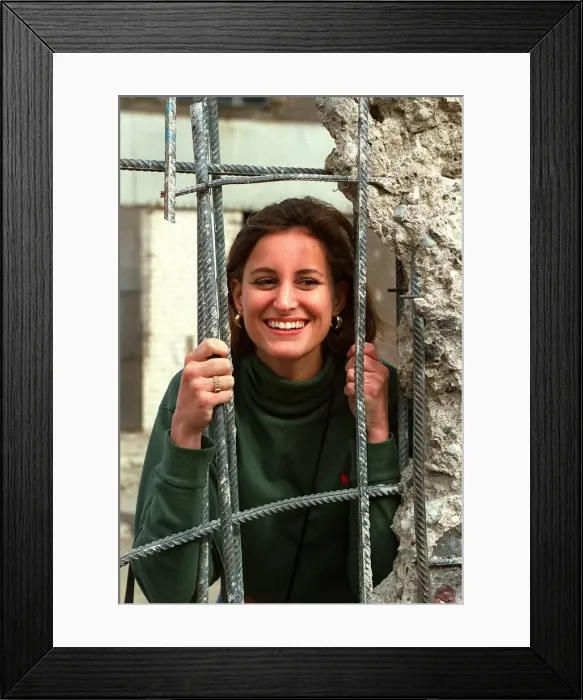 Framed Print : Young woman looks through a hole in the Berlin wall-pictured on the Jean Rook trip to Framed Print : Young woman looks through a hole in the Berlin wall-pictured on the Jean Rook trip to