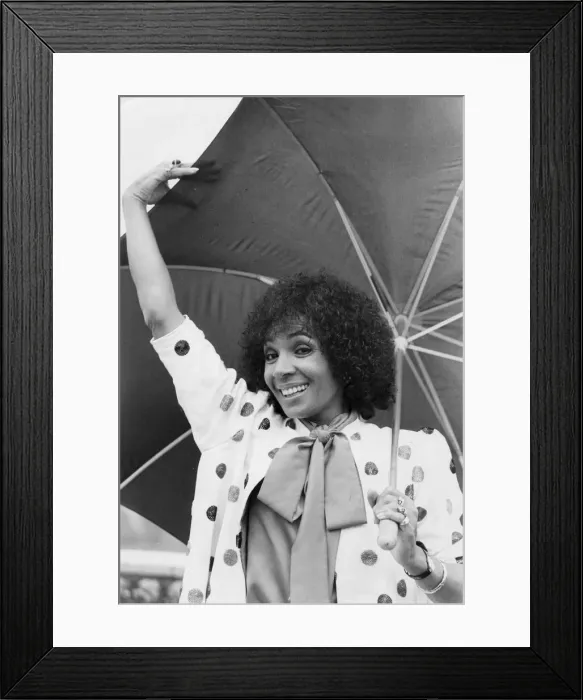 Framed Print : Shirley Bassey smiling under umbrella - September 1982 02  /  09  /  1982