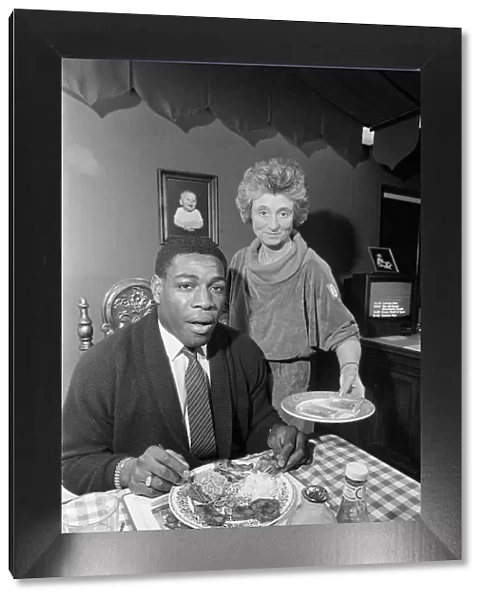 FRANK BRUNO EATING FOOD SERVED BY SYLVIA LAWLESS 10  /  04  /  1986