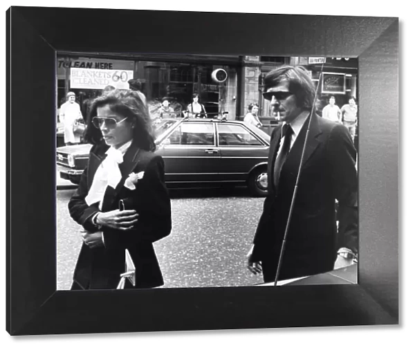 Bianca Jagger and John Paul Getty II walking in London street - June 1976