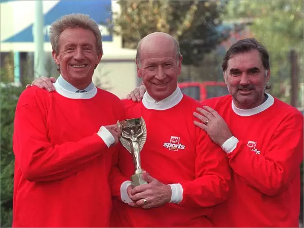 Denis Law with Bobby Charlton and George Best hold 1966 World Cup replica
