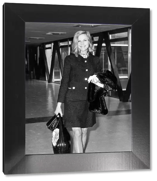 Honor Blackman wearing mini skirt two piece suit at London airport - April 1969