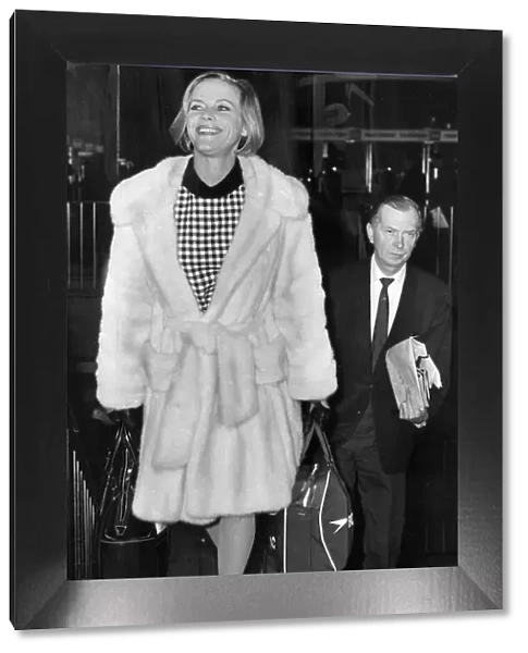 Honor Blackman wearing white fur coat at London airport - January 1968