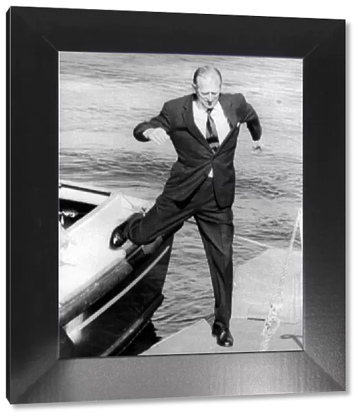 The Duke of Edinburgh. Prince Philip leaps from a boat onto the quay during a visit to