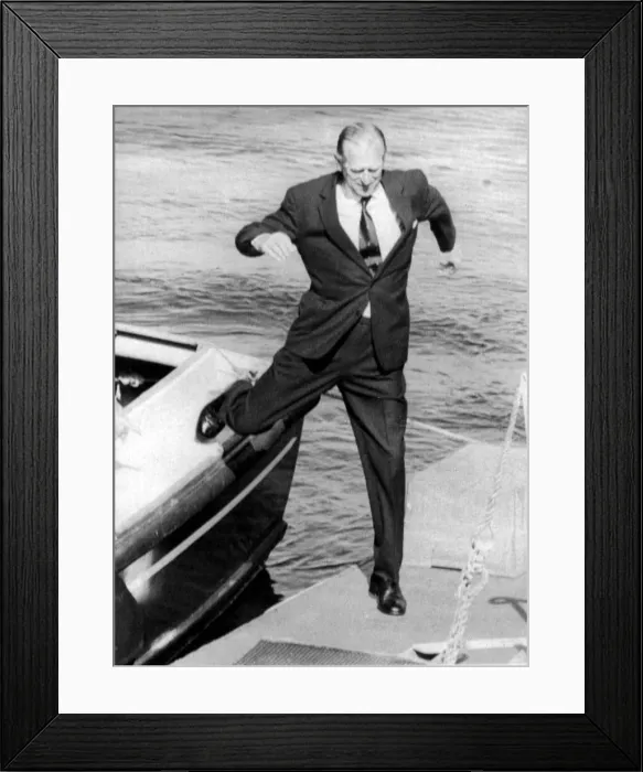 Framed Print : The Duke of Edinburgh. Prince Philip leaps from a boat onto the quay during a visit to Framed Print : The Duke of Edinburgh. Prince Philip leaps from a boat onto the quay during a visit to
