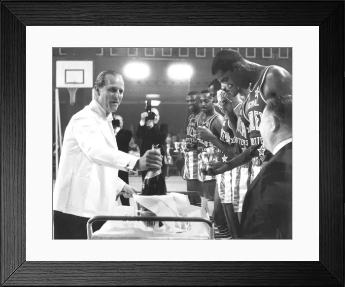 Framed Print : The Duke pours champagne for the Globe Trotters: The Duke of Edinburgh pours for members