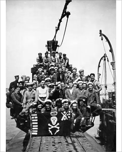 The crew of HMS Sportsman pose on the deck of their submarine at a un-named Northern