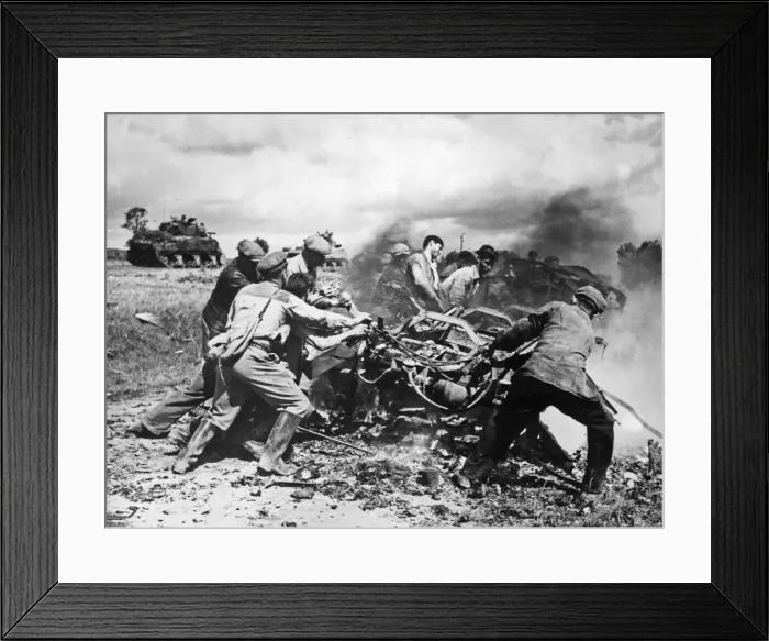Framed Print : Members of the French Forces of the Interior clear away burning vehicles on the main road