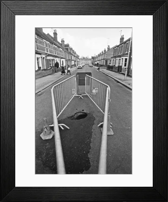 Framed Print : Barriers erected around a large hole in Norfolk Road, Reading, which suddenly appeared Framed Print : Barriers erected around a large hole in Norfolk Road, Reading, which suddenly appeared