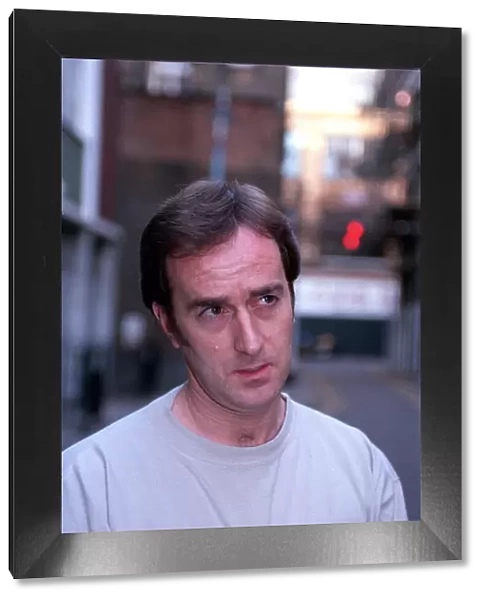 ANGUS DEAYTON WEARING T-SHIRT AND JEANS OUTSIDE SAVING HIS SOHO OFFICE IN LONDON