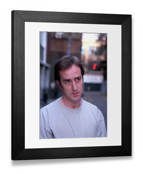 Framed Print : ANGUS DEAYTON WEARING T-SHIRT AND JEANS OUTSIDE SAVING HIS SOHO OFFICE IN LONDON