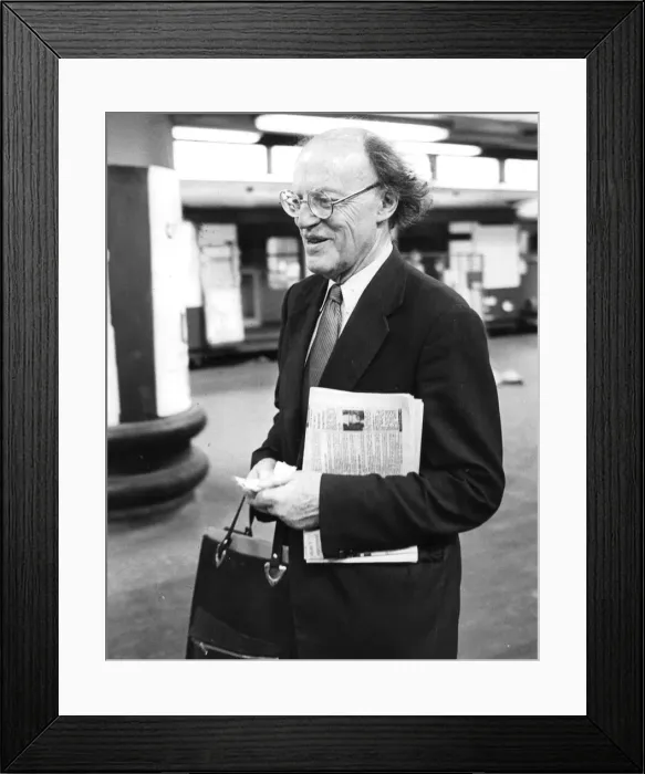 Framed Print : Lord Frank Longford carrying copy of tabloid newspaper at Euston station