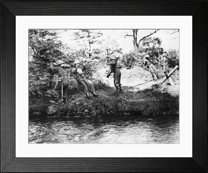 Framed Print : Monmouthshire Home Guard negotisting a river by means of a slender wire bridge of their Framed Print : Monmouthshire Home Guard negotisting a river by means of a slender wire bridge of their