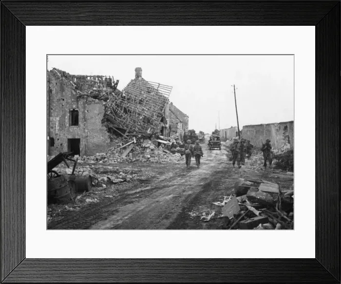 Framed Print : The advance towards Caen. Infantry making their way through the ruined village of Lebisey Framed Print : The advance towards Caen. Infantry making their way through the ruined village of Lebisey