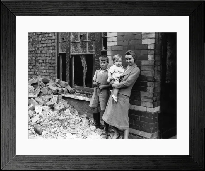 Framed Print : A woman and children standing amongst the rubble outside a building in South Wales Framed Print : A woman and children standing amongst the rubble outside a building in South Wales