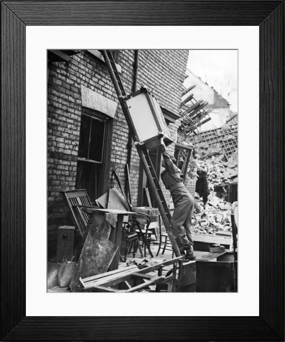 Framed Print : A soldier helping to move luggage from a home that has been hit by the Luftwaffe in Framed Print : A soldier helping to move luggage from a home that has been hit by the Luftwaffe in