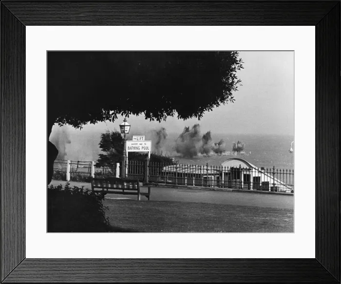 Framed Print : A salvo of bombs dropping into the sea off a South East coast town during Second World
