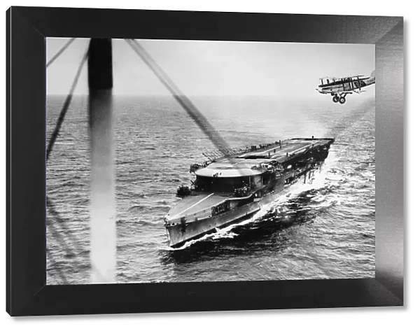 A plane from HMS Furious passing over the aircraft carrier while manoeuvering to alight