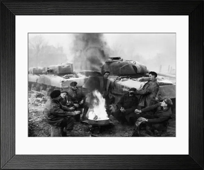 Framed Print : British soldiers of a tank recovery unit keep warm around a fire in the wintry weather