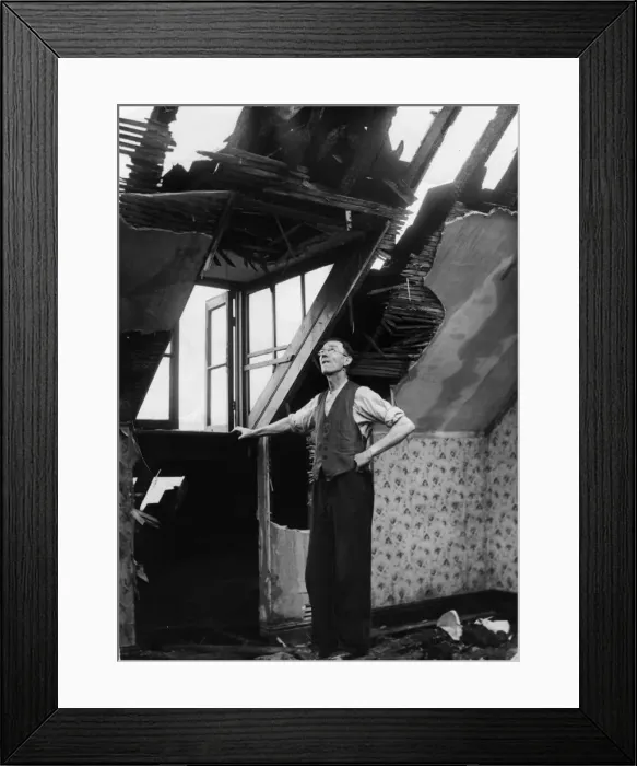 Framed Print : A resident of an East Yorkshire town surveys the damage to his home caused by a German