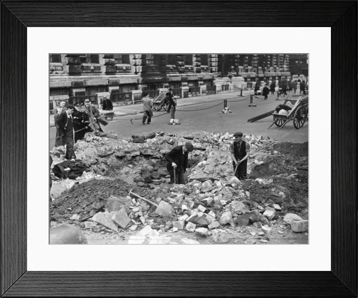 Framed Print : A large bomb crater which narrowly missed two business offices during Thursday nights Framed Print : A large bomb crater which narrowly missed two business offices during Thursday nights