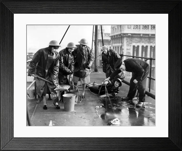 Framed Print : Office girls on a city roof being instructed how to fight an incendiary bomb Framed Print : Office girls on a city roof being instructed how to fight an incendiary bomb