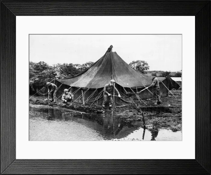 Framed Print : A group of American soldiers build a dam to keep the river from flooding after it burst Framed Print : A group of American soldiers build a dam to keep the river from flooding after it burst