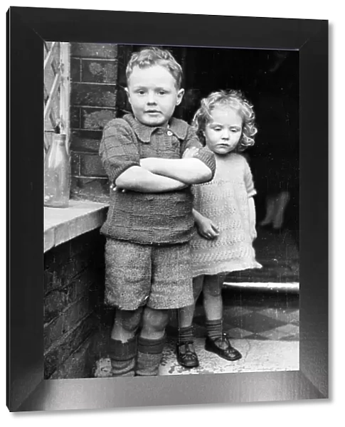 Freddie Harrison, 6, and his sister Winifred, 3, whom he saved from the ruins of their