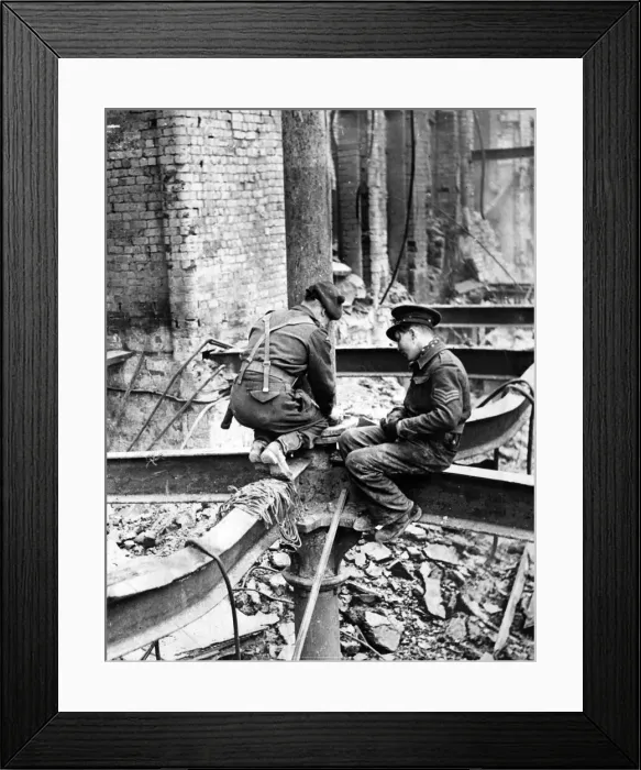 Framed Print : Members of H. M Forces perched on a girder as they place a charge of gelignite in position Framed Print : Members of H. M Forces perched on a girder as they place a charge of gelignite in position