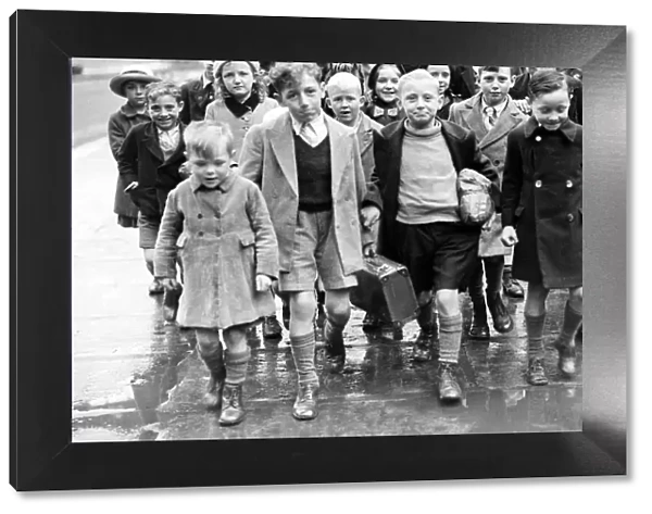 Mrs Rivers walking with evacuee children at St Pancras. They are returning from Suffolk
