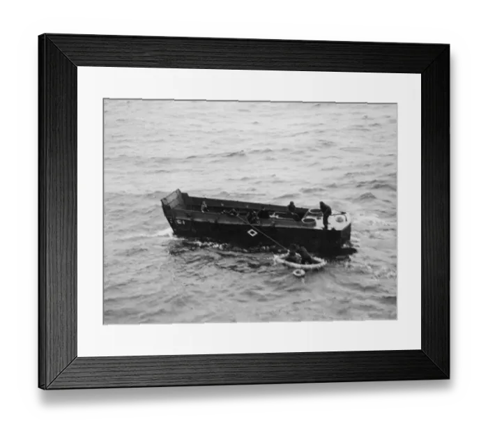 Framed Print : A Royal Navy landing craft picking up American survivors in Invasion Bay following a
