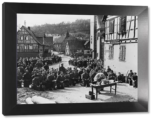 German civilians stand and stare in awe, heads bowed as they watch Palm Sunday services