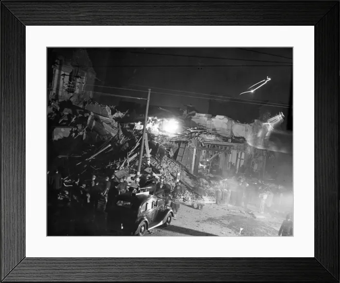 Framed Print : Rescue workers engaged in a heap of debris after a bomb had struck a London dancehall Framed Print : Rescue workers engaged in a heap of debris after a bomb had struck a London dancehall