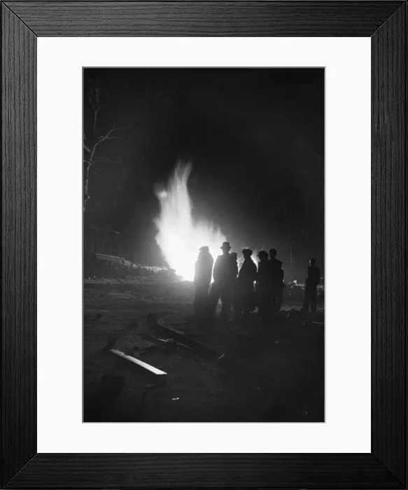 Framed Print : A small fire burns, one of many, across London, during The Blitz of World War Two Framed Print : A small fire burns, one of many, across London, during The Blitz of World War Two