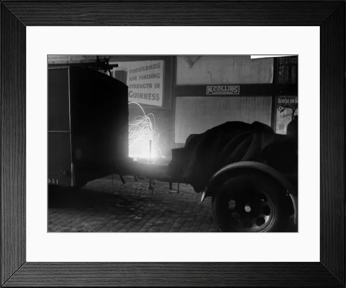 Framed Print : Incendiary bomb detonates close to a fire engine in the City of London. October 1940 Framed Print : Incendiary bomb detonates close to a fire engine in the City of London. October 1940