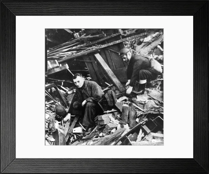 Framed Print : Two members of the emergency services sift through the rubble after another air raid Framed Print : Two members of the emergency services sift through the rubble after another air raid