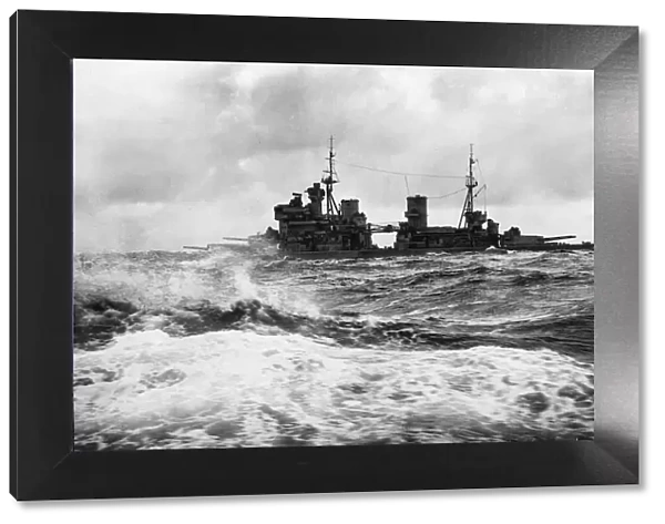 Royal Navy Battleship HMS King George V crosses the rough seas of the Atlantic Ocean