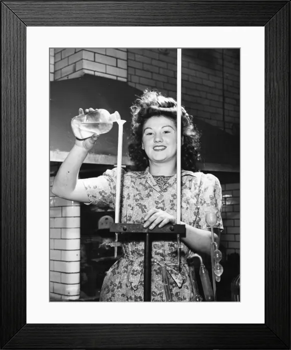 Framed Print : Picture shows Joyce Richardson, a munitions worker. She is pouring a liquid down a Framed Print : Picture shows Joyce Richardson, a munitions worker. She is pouring a liquid down a